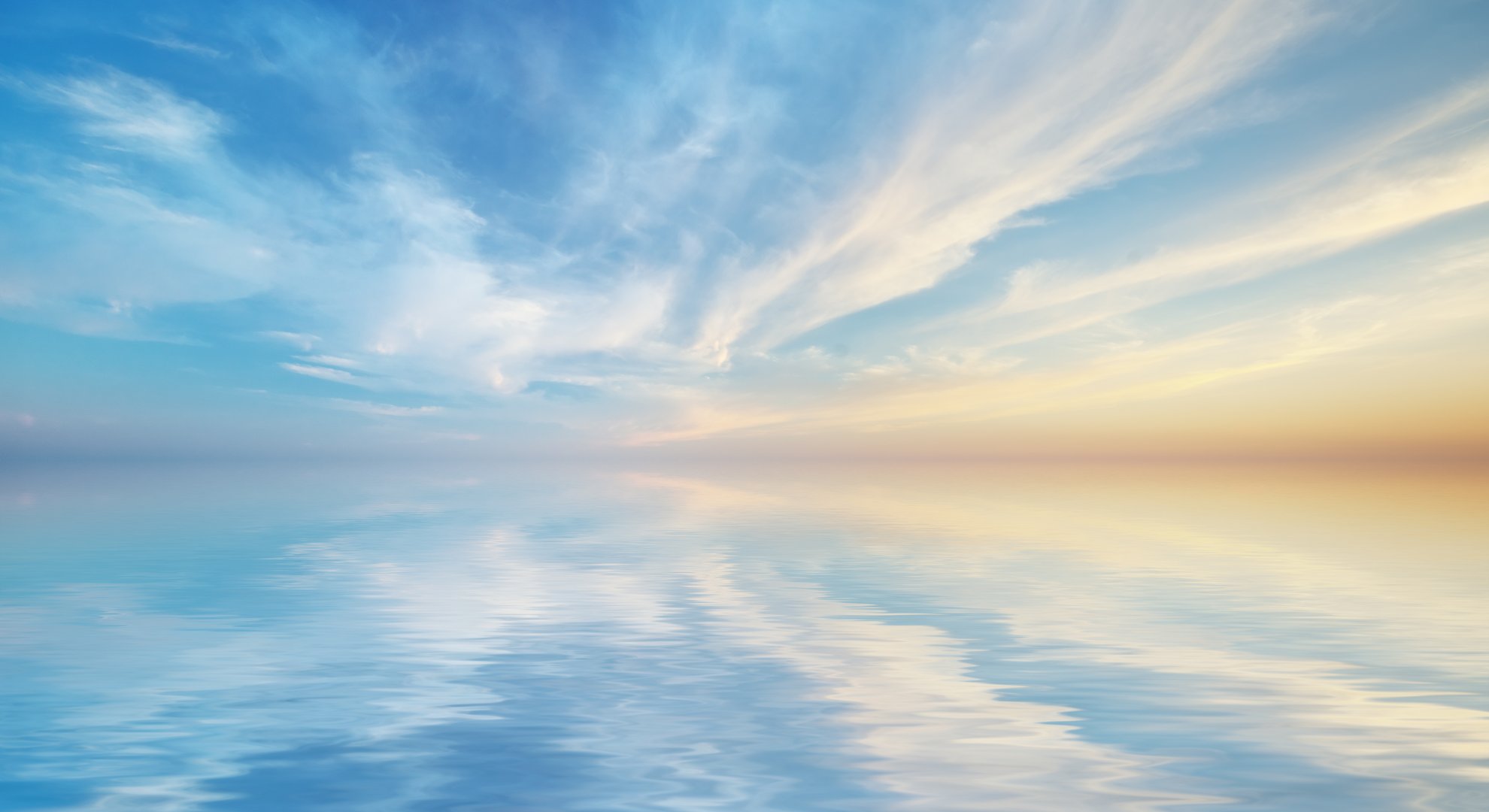 Soft sky reflected in calm water